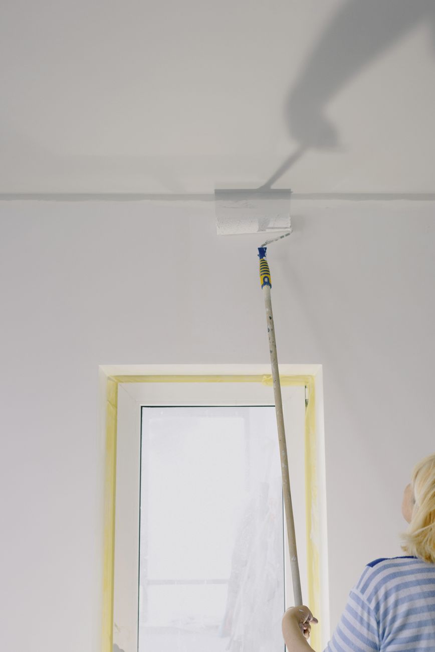 Joiner at work on a door frame in a Bootle hallway